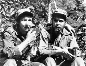 Raul Castro, left, younger brother of Cuban rebel leader Fidel, has his arm around second-in-command, Ernesto "Che" Guevara, Argentine national, in their Sierra de Cristal Mountain stronghold south of Havana, Cuba, during the Cuban revolution in this June 1958 file photo. (AP Photo/Andrew St. George)