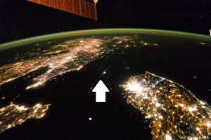 AP10ThingsToSee - This Jan. 30, 2014 photo made available by NASA on Monday, Feb. 24, 2014 shows North Korea, darker area at center, between South Korea, right, and China, left. Lights from the North Korean capital, Pyongyang, are visible at center. The image comparing the night time lights of the countries was made by the Expedition 38 crew aboard the International Space Station. (AP Photo/NASA, File)